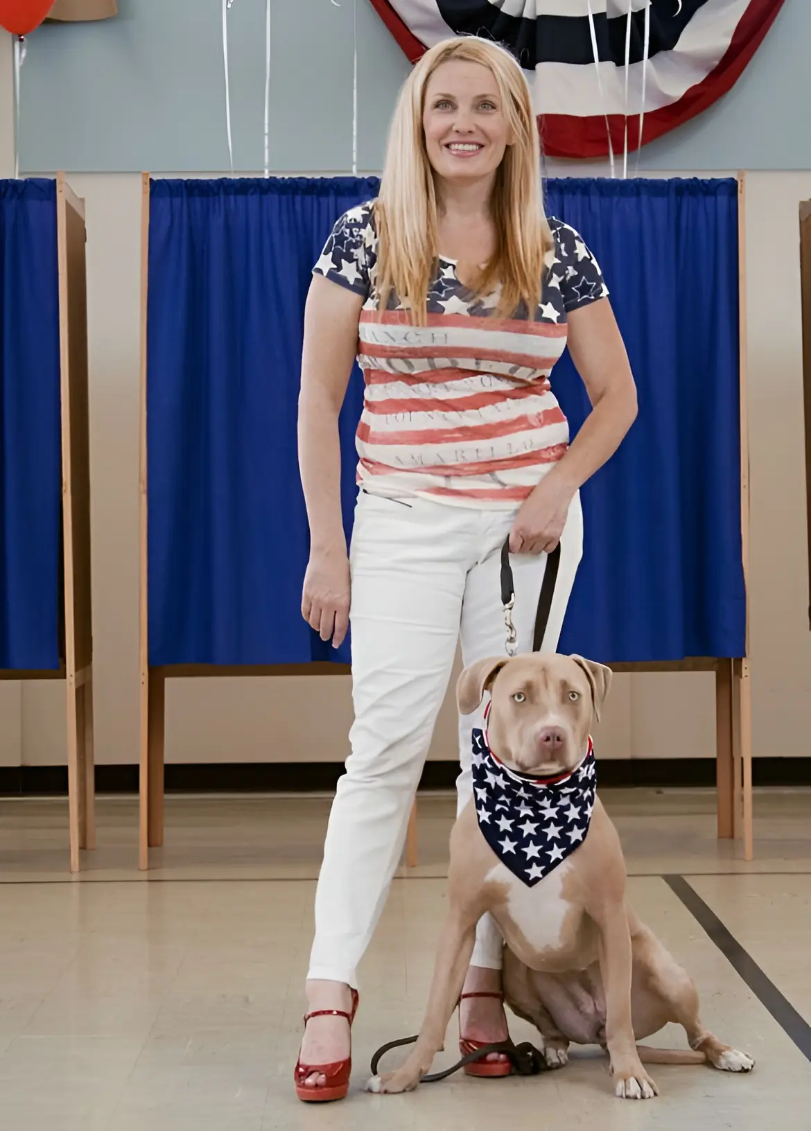 Woman and dog wearing American flag outfits.