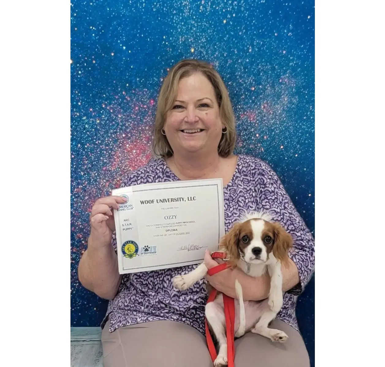 Smiling woman holding certificate and puppy