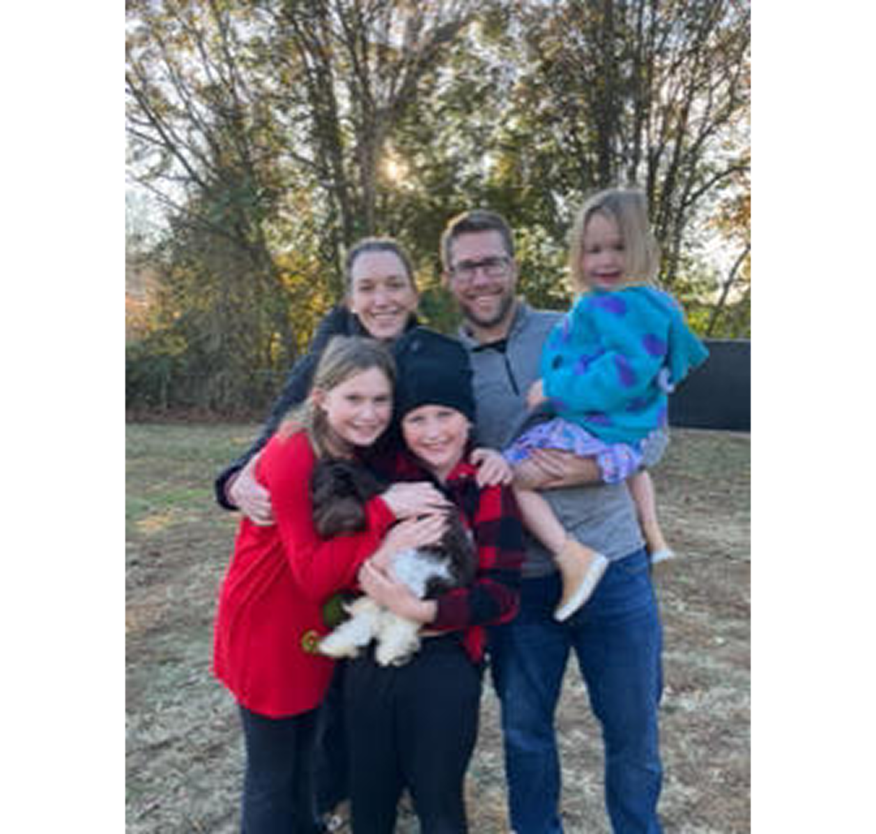Smiling family with children and small dog