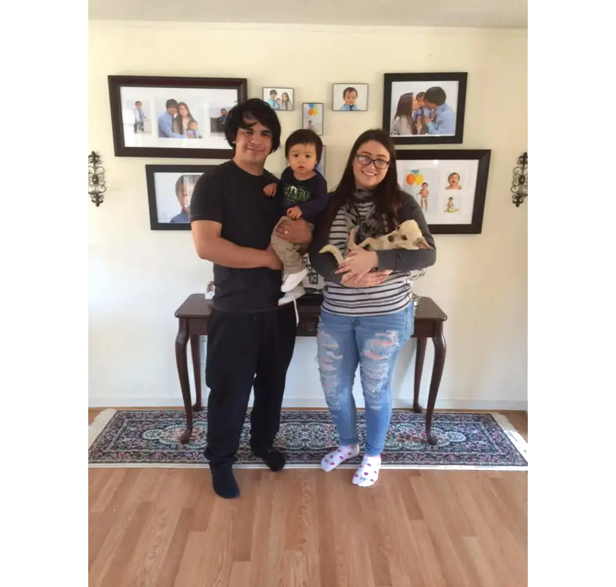 Smiling family portrait with baby and puppy