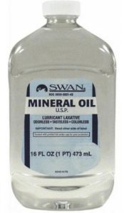 A bottle of oil is shown with the label.