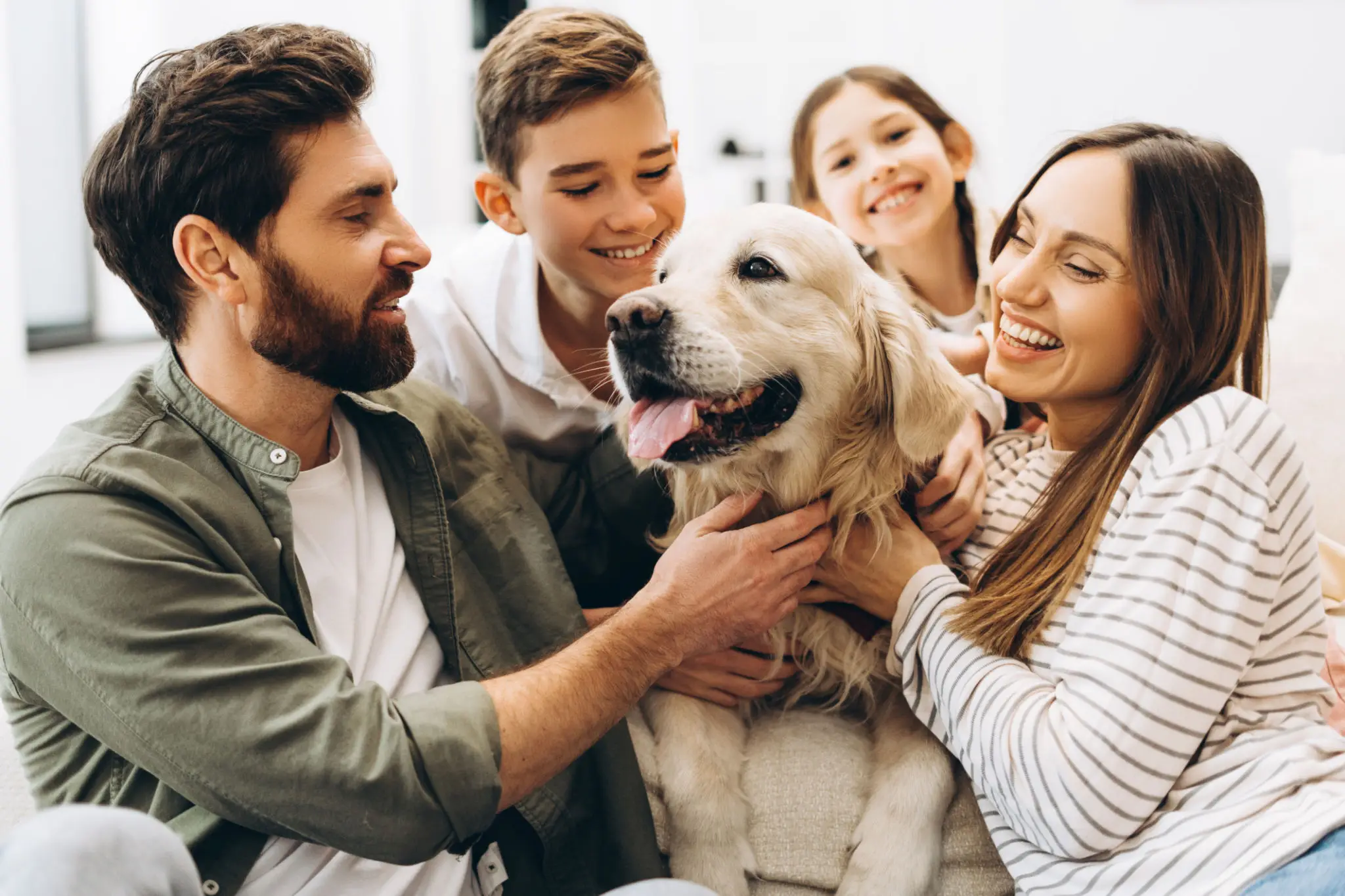 Family enjoying time with their golden retriever.