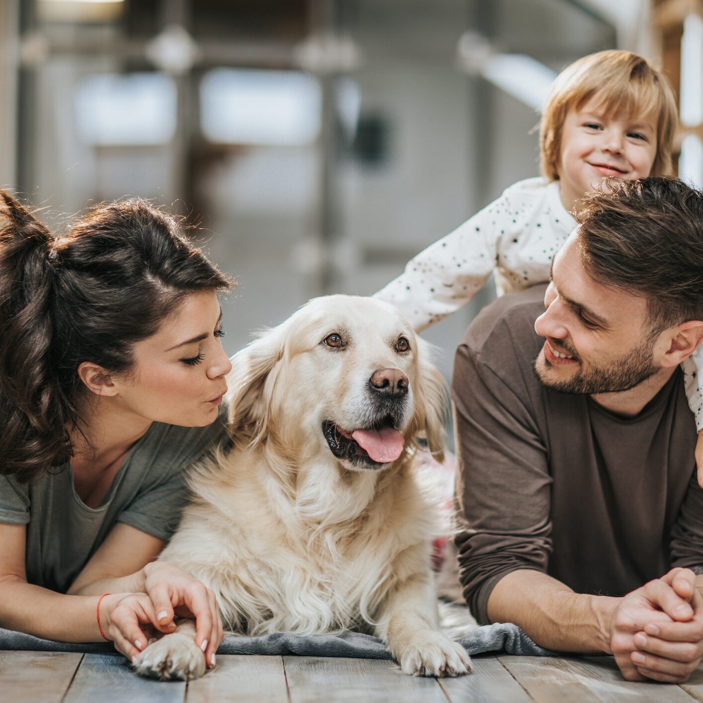 Family with dog lying on the floor.